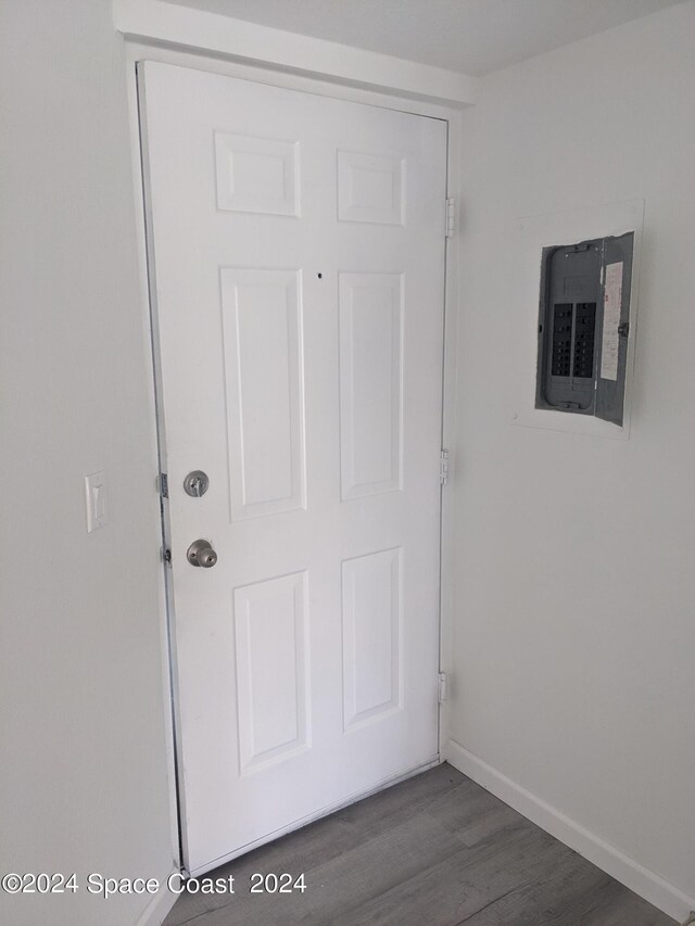 interior space with dark wood-type flooring and electric panel