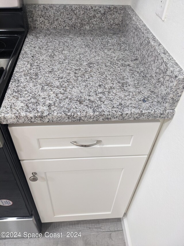 interior details with white cabinets and light stone counters