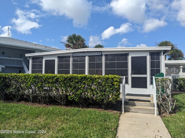 view of front of home with a sunroom