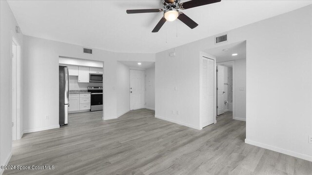 unfurnished living room with light wood-type flooring and ceiling fan