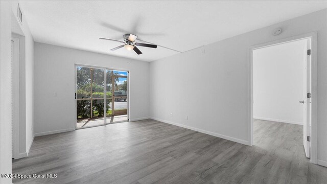 spare room featuring wood-type flooring and ceiling fan