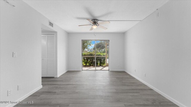 unfurnished room featuring ceiling fan and hardwood / wood-style flooring