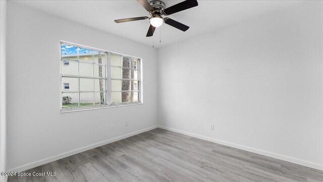 unfurnished room with light hardwood / wood-style floors, ceiling fan, and a wealth of natural light