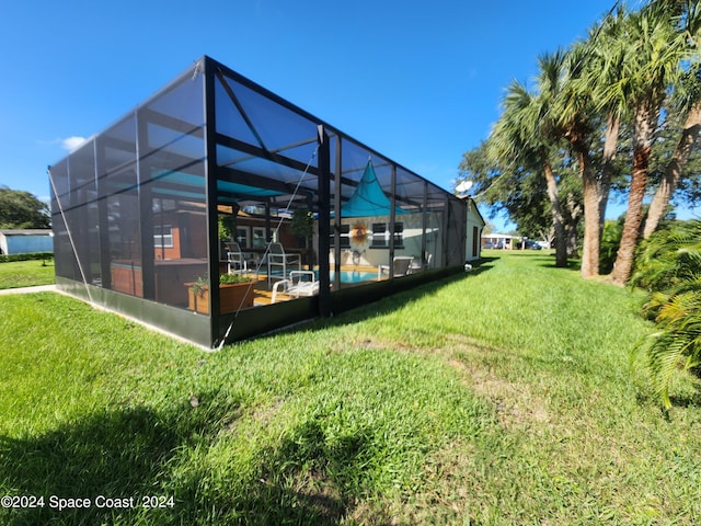 view of yard with glass enclosure