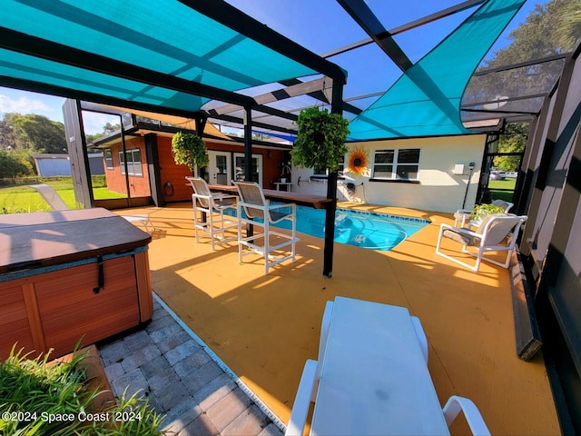 view of pool with a lanai, a patio, and a hot tub