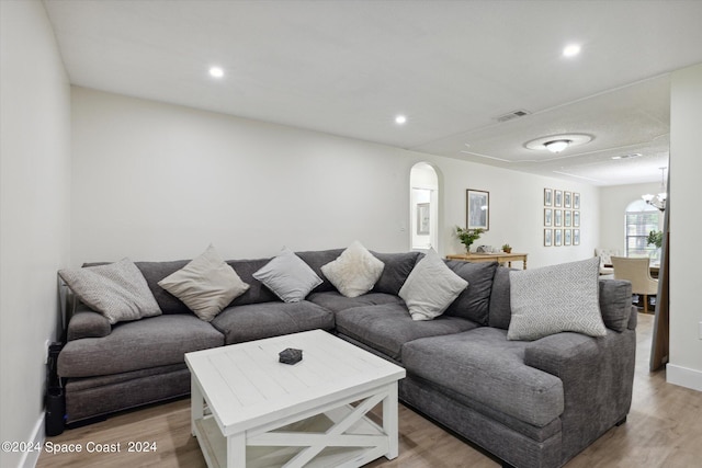 living room featuring light hardwood / wood-style floors and an inviting chandelier