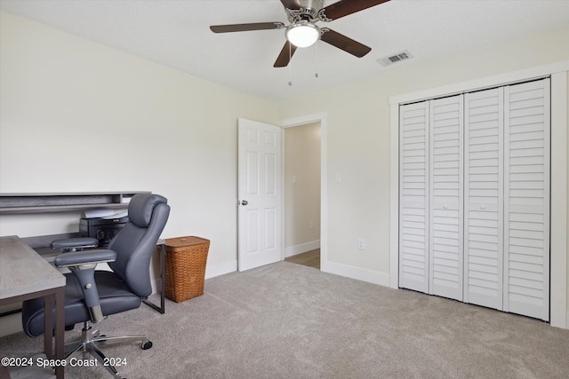 carpeted office space with ceiling fan