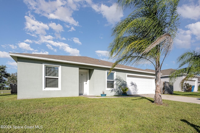 ranch-style house featuring a front yard and a garage