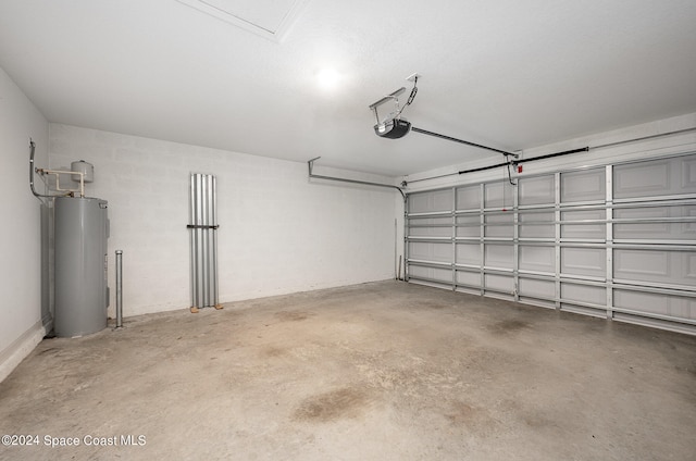 garage featuring water heater and a garage door opener