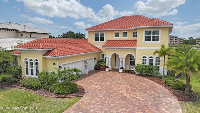 mediterranean / spanish-style home featuring a garage