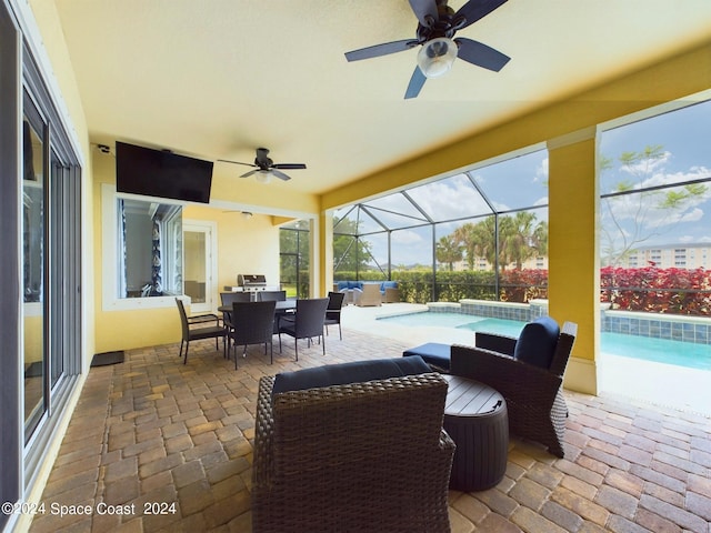 view of patio / terrace featuring glass enclosure, a swimming pool with hot tub, and ceiling fan