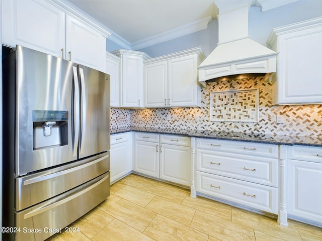 kitchen with custom range hood, crown molding, white cabinetry, stainless steel fridge with ice dispenser, and backsplash