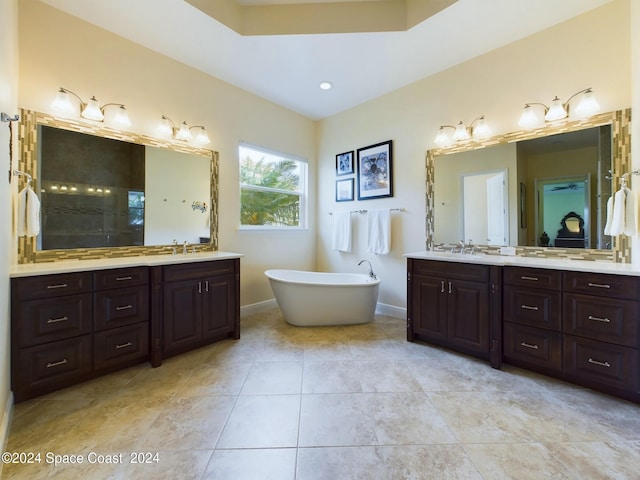 bathroom featuring independent shower and bath, vanity, and tile patterned flooring