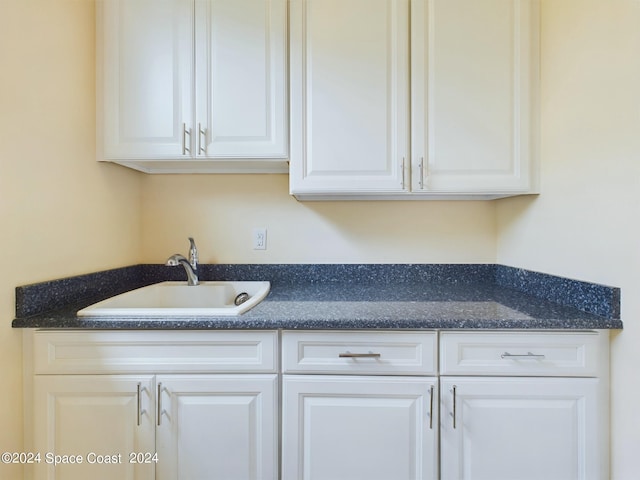 kitchen featuring white cabinets and sink