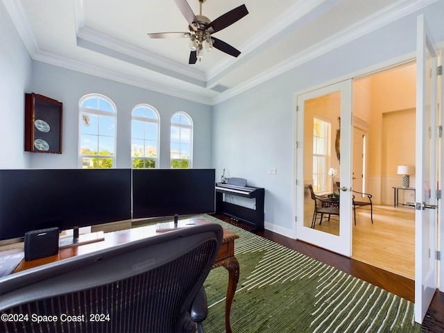 home office with hardwood / wood-style flooring, crown molding, french doors, and a raised ceiling