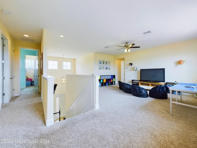 carpeted living room featuring ceiling fan