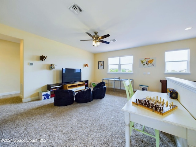 carpeted living room featuring ceiling fan