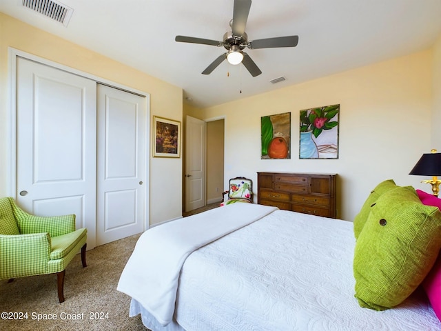 bedroom featuring ceiling fan, a closet, and carpet