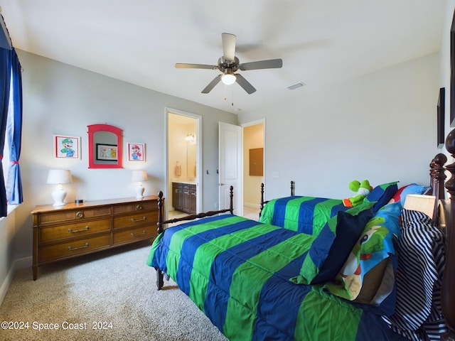 carpeted bedroom with ceiling fan and ensuite bath