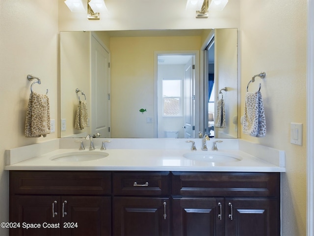 bathroom featuring toilet and vanity