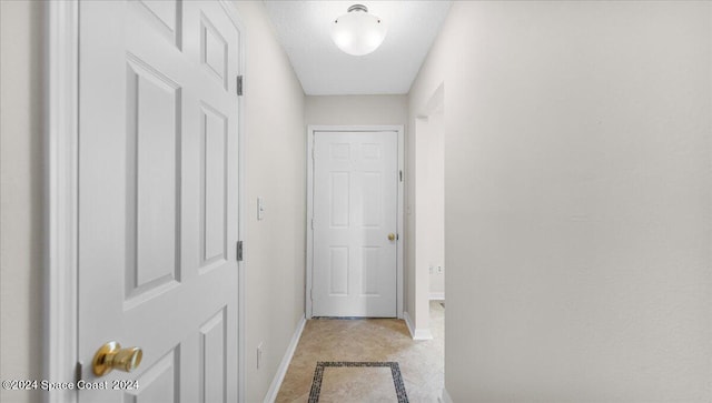 corridor featuring a textured ceiling