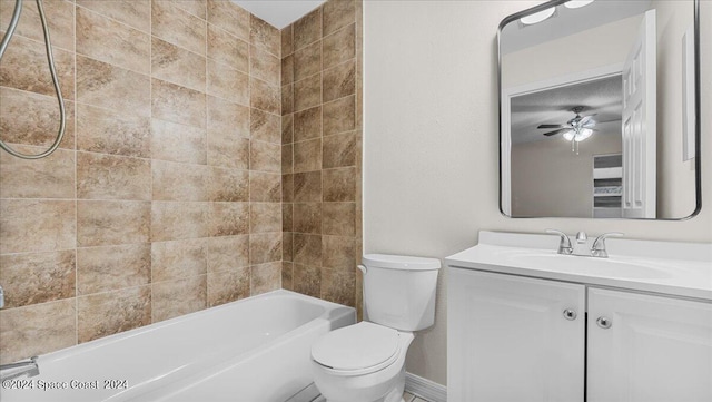 full bathroom with ceiling fan, vanity, toilet, and tiled shower / bath combo