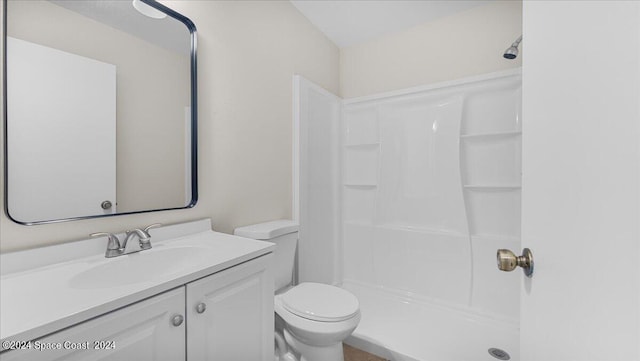 bathroom featuring walk in shower, vanity, and toilet