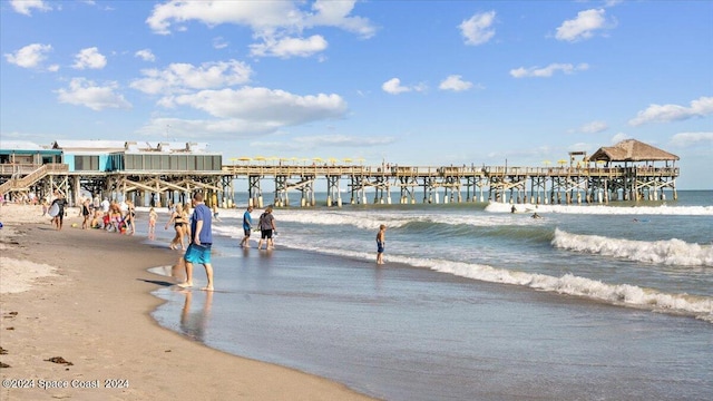 view of home's community featuring a water view and a view of the beach