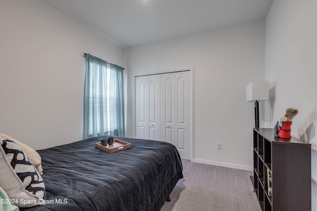 bedroom featuring a closet and light colored carpet