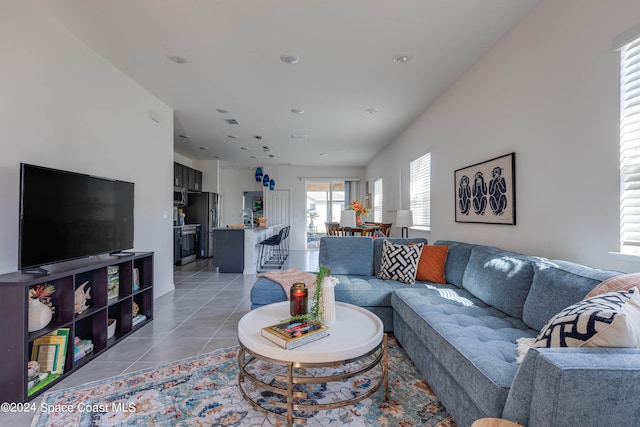 living room with sink and light tile patterned floors