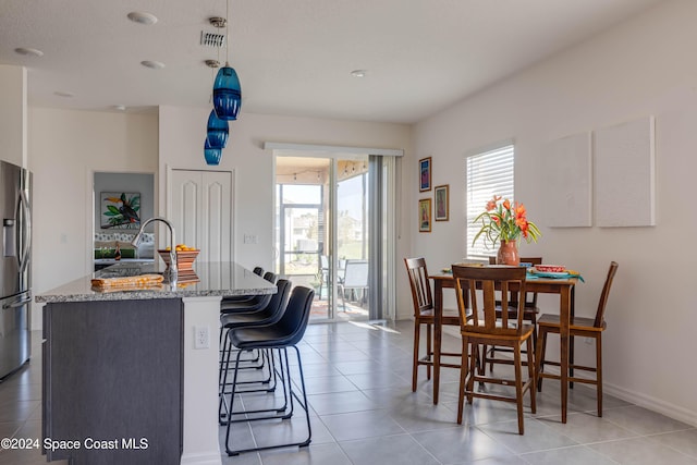 dining area featuring light tile patterned flooring and sink