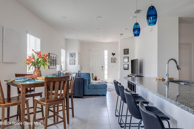 dining room featuring light tile patterned flooring and sink