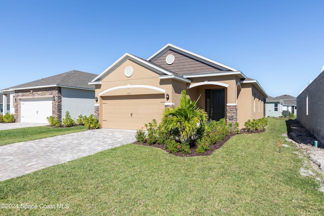 view of front of property with a front yard and a garage