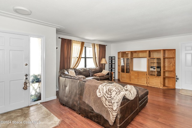 living room with ornamental molding and wood finished floors