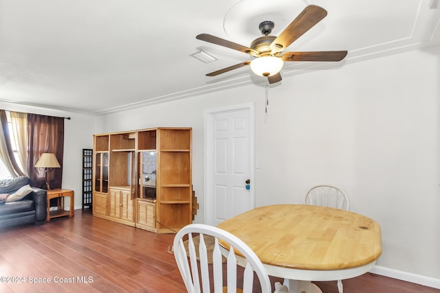 dining room featuring visible vents, baseboards, ceiling fan, and wood finished floors