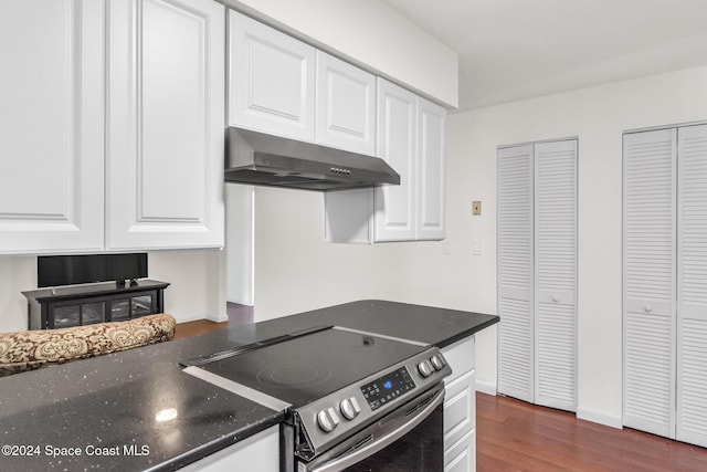 kitchen featuring dark wood finished floors, white cabinetry, under cabinet range hood, and stainless steel electric stove