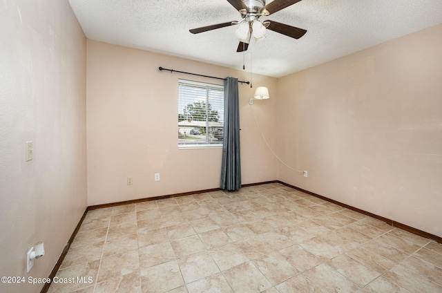 unfurnished room featuring ceiling fan and a textured ceiling