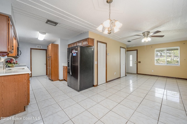 kitchen featuring black refrigerator with ice dispenser, a textured ceiling, sink, and light tile patterned floors