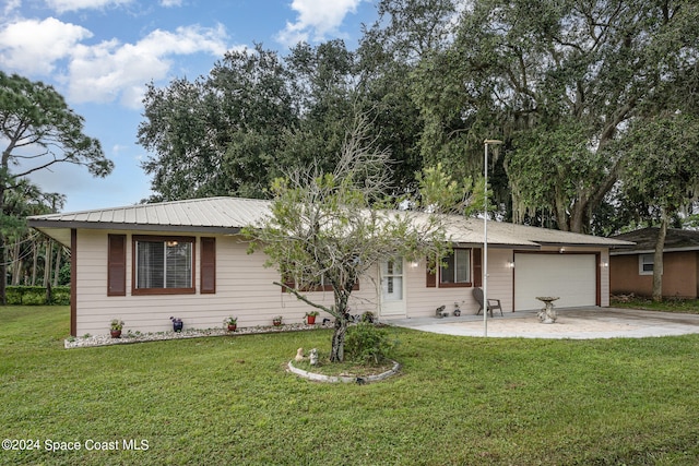 ranch-style home with a garage and a front lawn