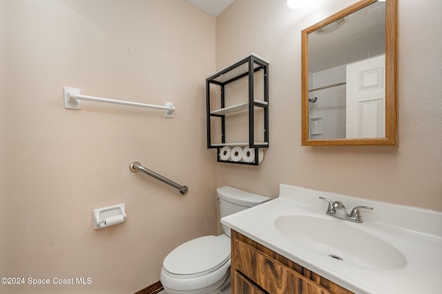 bathroom featuring toilet and vanity