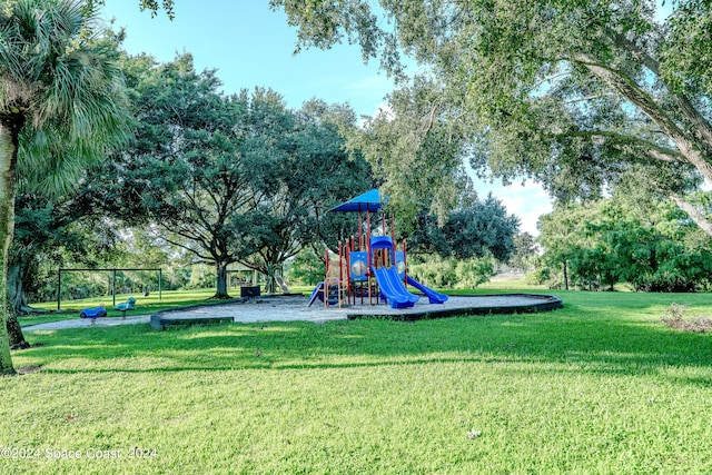 view of jungle gym featuring a lawn