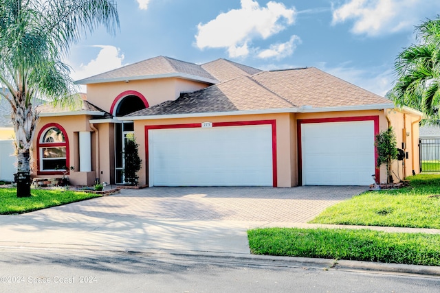 view of front of house with a front yard and a garage