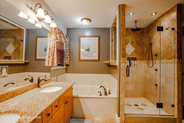 bathroom featuring a sink, a stall shower, a tub with jets, and double vanity