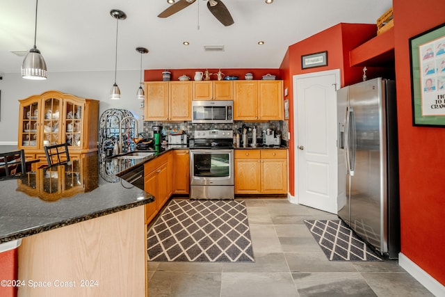 kitchen featuring ceiling fan, lofted ceiling, sink, decorative light fixtures, and stainless steel appliances