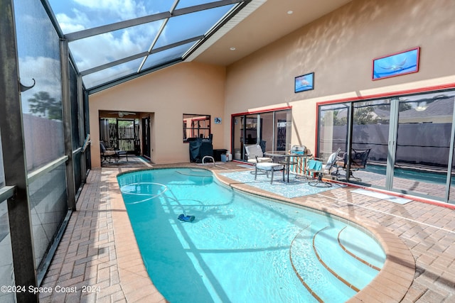 view of pool featuring a patio, ceiling fan, a fenced in pool, and a lanai