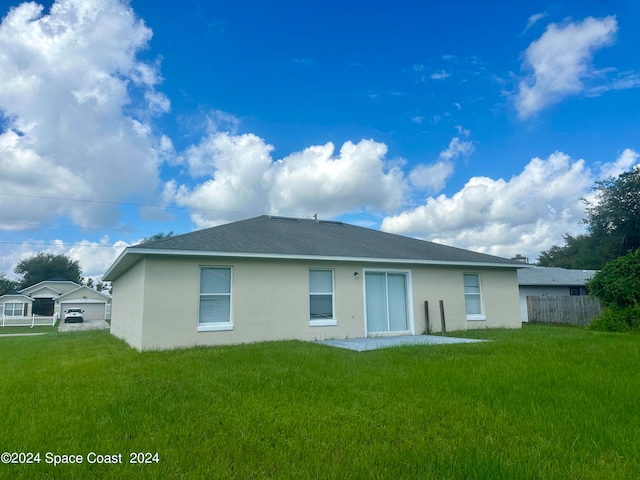 rear view of property with a lawn