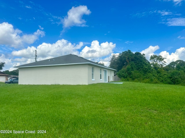 view of property exterior featuring a lawn