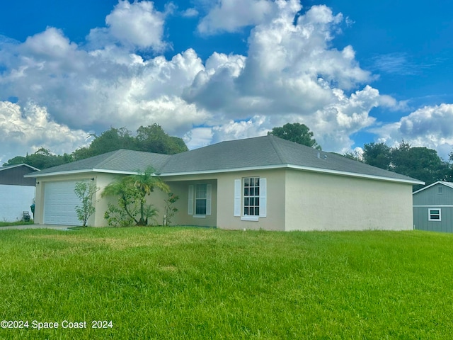 single story home with a garage and a front yard