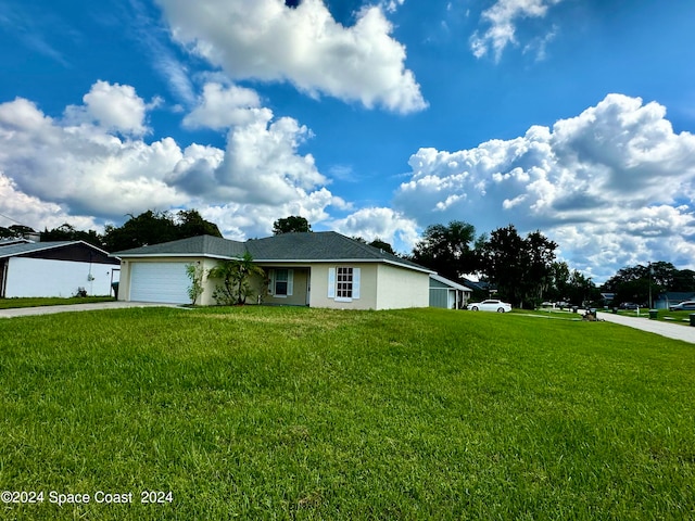 ranch-style home featuring a garage and a front lawn