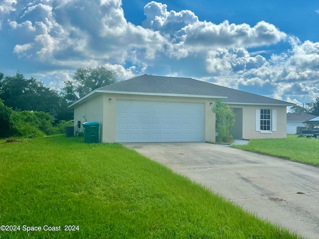 single story home featuring a front lawn and a garage